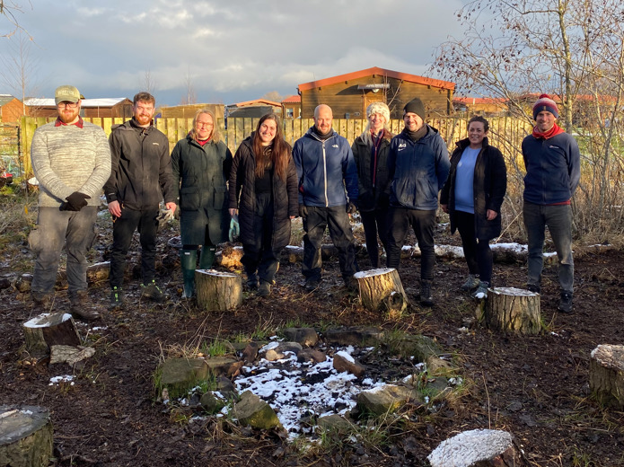 Colleagues from NEPO and EDF stand in a clearing in some woodland at PACTNE site following the renovation works.